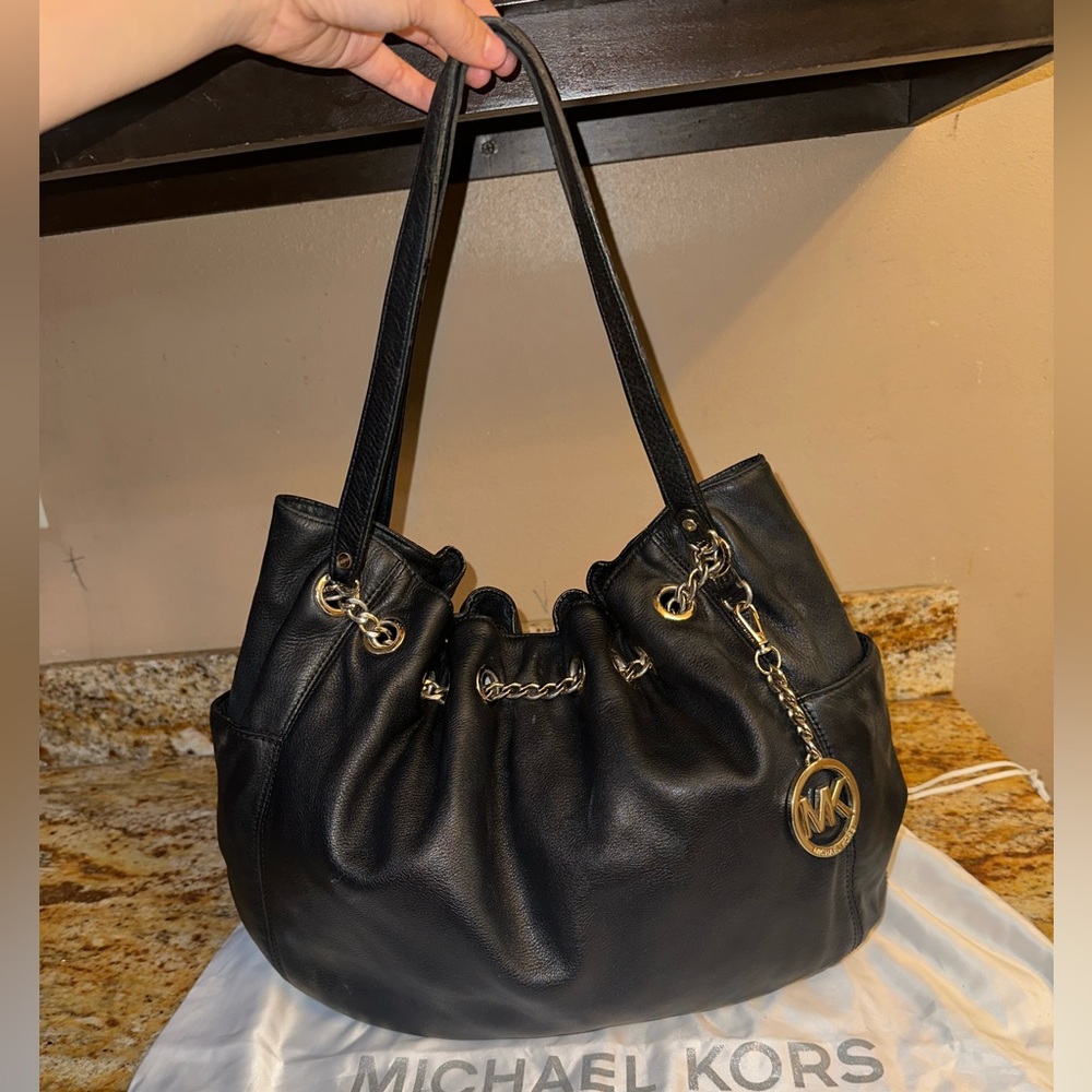 Michael Korrs black leather purse